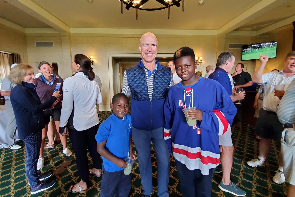 Mark Messier with two students at a Foundation event