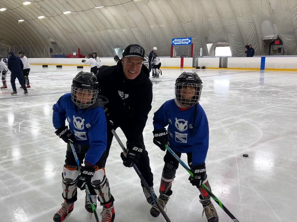 Mark Messier on the ice with two young players at a North Park Hockey session